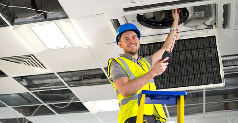 HVAC technician working on hvac unit